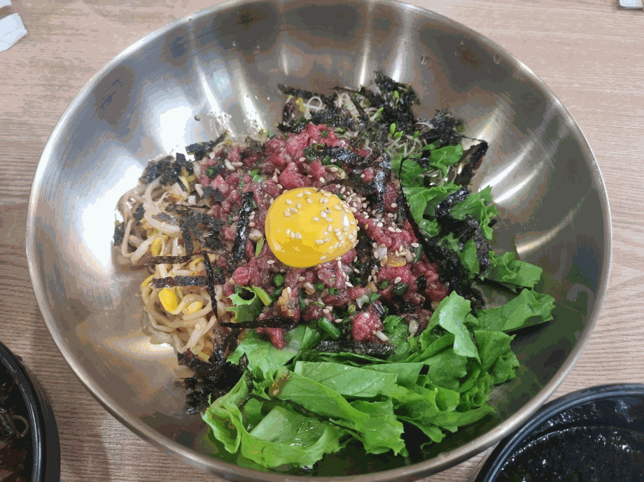 Yukhoe bibimbap - Korean raw beef tartare bibimbap with egg yolk